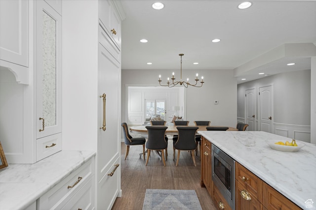 5040 S 1450 E, Ogden, UT 84403 - kitchen featuring stainless steel microwave, white cabinetry, a chandelier, recessed lighting, and dark wood-type flooring