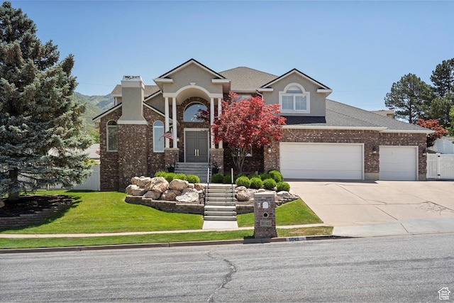 5040 S 1450 E, Ogden, UT 84403 - view of front facade featuring concrete driveway, brick siding, a shingled roof, and an attached garage