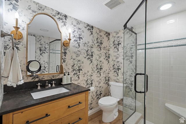 5040 S 1450 E, Ogden, UT 84403 - bathroom featuring a shower stall, vanity, wood finished floors, and a textured ceiling