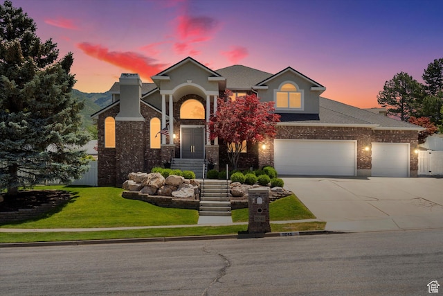 5040 S 1450 E, Ogden, UT 84403 - traditional-style house featuring concrete driveway, a yard, brick siding, and a garage