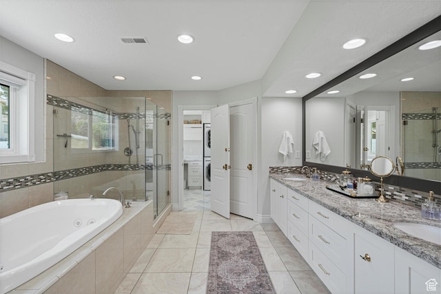 5040 S 1450 E, Ogden, UT 84403 - bathroom featuring recessed lighting, a whirlpool tub, a stall shower, double vanity, and estacked washer and dryer