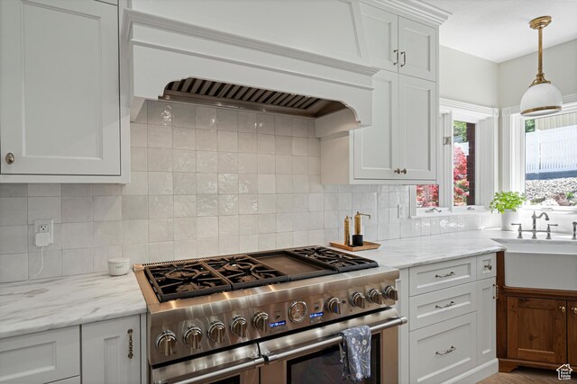 5040 S 1450 E, Ogden, UT 84403 - kitchen with range with two ovens, tasteful backsplash, white cabinetry, and light stone countertops