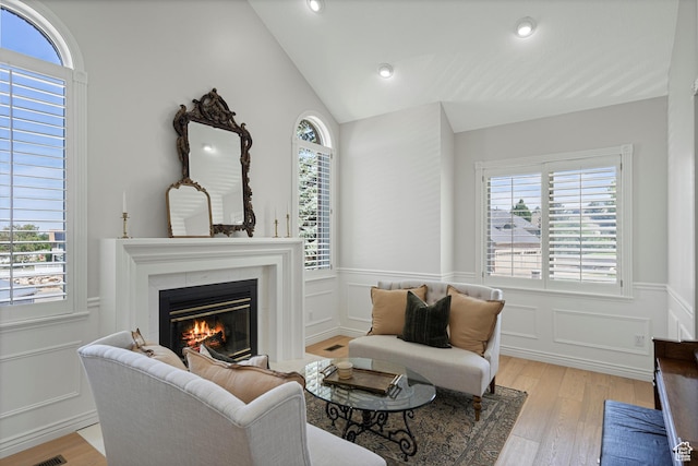 5040 S 1450 E, Ogden, UT 84403 - living room featuring a glass covered fireplace, wainscoting, light wood-style flooring, lofted ceiling, and recessed lighting