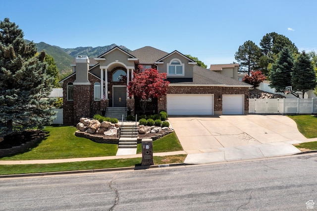 5040 S 1450 E, Ogden, UT 84403 - view of front of house with driveway, a garage, brick siding, and a shingled roof