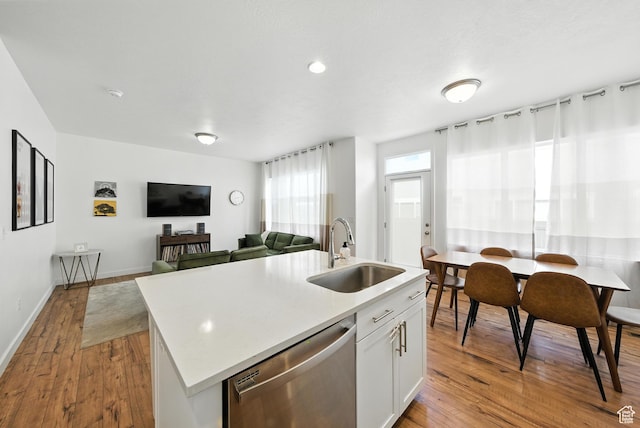 15104 S Halter Way, Bluffdale, UT 84065 - kitchen with stainless steel dishwasher, wood finished floors, a kitchen island with sink, light countertops, and white cabinets