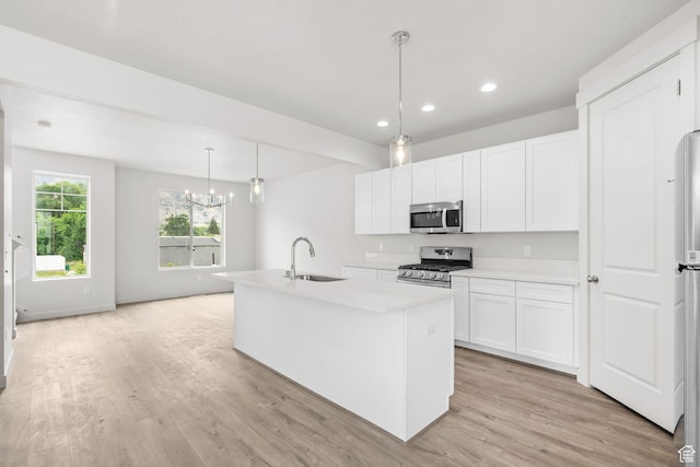 688 E 500 S Unit 108, Provo, UT 84606 - kitchen with appliances with stainless steel finishes, recessed lighting, light wood-style flooring, light countertops, and white cabinetry