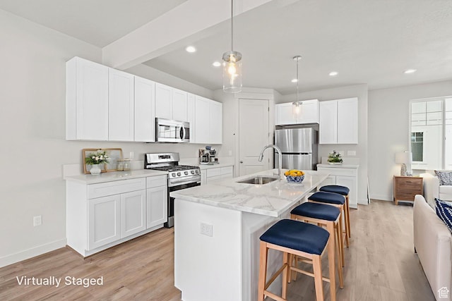 688 E 500 S Unit 108, Provo, UT 84606 - kitchen with stainless steel appliances, light wood-style floors, a breakfast bar, white cabinetry, and recessed lighting