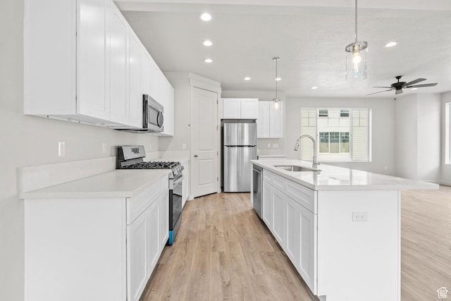 688 E 500 S Unit 108, Provo, UT 84606 - kitchen with appliances with stainless steel finishes, light wood-style floors, recessed lighting, light countertops, and white cabinets