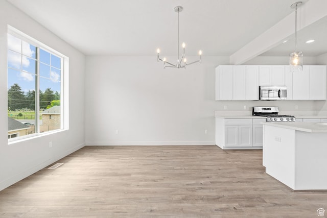 688 E 500 S Unit 108, Provo, UT 84606 - kitchen featuring stainless steel appliances, a chandelier, light countertops, light wood-style flooring, and white cabinets