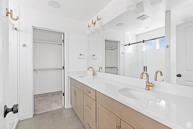 4397 W Bromwell Ct, Lehi, UT 84043 - bathroom featuring a spacious closet, double vanity, and tile patterned floors