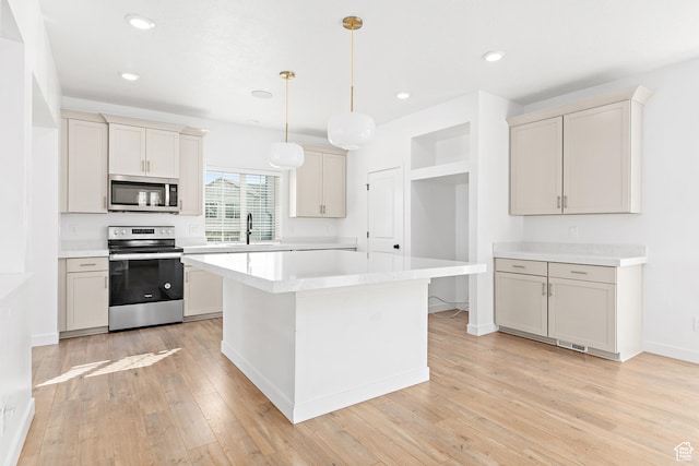 4397 W Bromwell Ct, Lehi, UT 84043 - kitchen featuring stainless steel appliances, light countertops, light wood finished floors, a center island, and hanging light fixtures