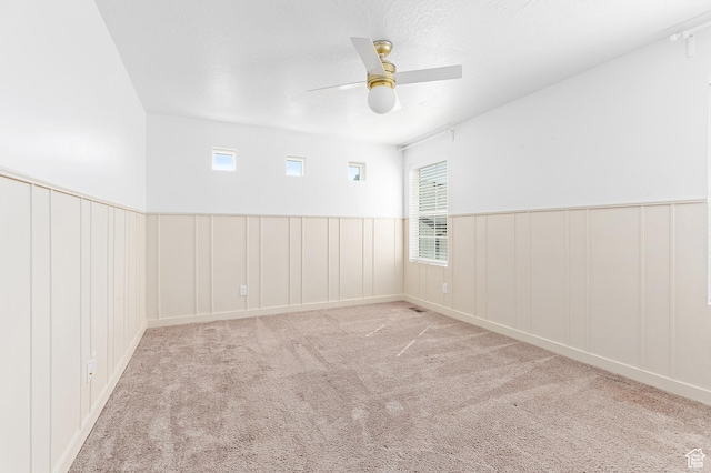 4397 W Bromwell Ct, Lehi, UT 84043 - spare room with ceiling fan, carpet flooring, wainscoting, a decorative wall, and healthy amount of natural light
