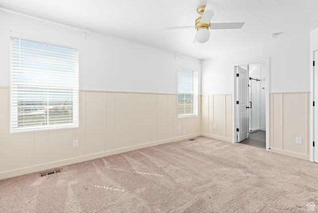 4397 W Bromwell Ct, Lehi, UT 84043 - unfurnished bedroom featuring carpet floors, wainscoting, ceiling fan, and ensuite bath