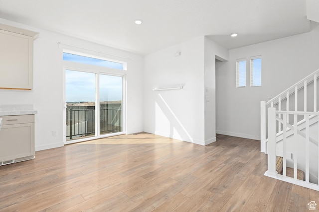 4397 W Bromwell Ct, Lehi, UT 84043 - unfurnished living room featuring light wood-style floors, recessed lighting, and stairway