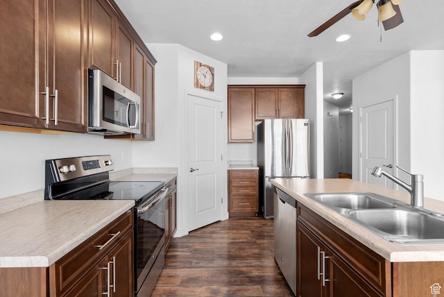 15218 S Tack Way, Bluffdale, UT 84065 - kitchen with stainless steel appliances, a ceiling fan, dark wood-style flooring, a kitchen island with sink, and light countertops