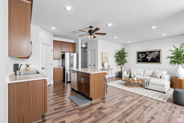 15218 S Tack Way, Bluffdale, UT 84065 - kitchen with appliances with stainless steel finishes, open floor plan, a center island, dark wood-style floors, and recessed lighting