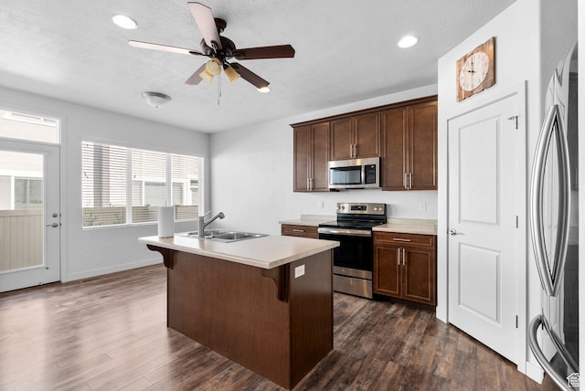15218 S Tack Way, Bluffdale, UT 84065 - kitchen featuring appliances with stainless steel finishes, a kitchen island with sink, ceiling fan, dark wood-style floors, and recessed lighting