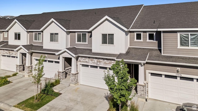 15218 S Tack Way, Bluffdale, UT 84065 - view of property with stone siding, a garage, board and batten siding, driveway, and a shingled roof