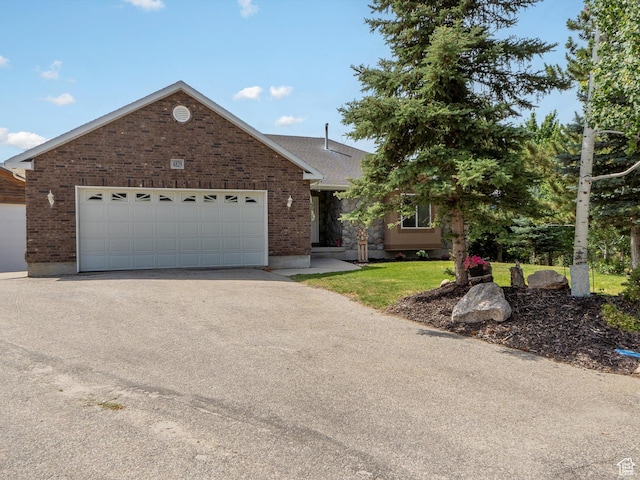 4829 E Patio Springs Cir N, Eden, UT 84310 - view of front of home featuring driveway, brick siding, and an attached garage