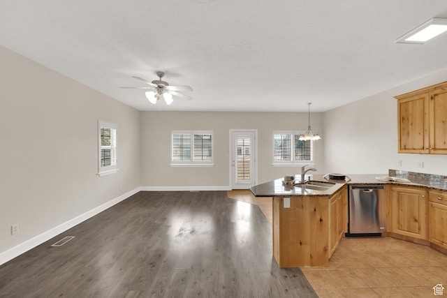 602 E Wyngate Pointe Ln S, Draper, UT 84020 - kitchen featuring dishwasher, a peninsula, plenty of natural light, and dark stone countertops