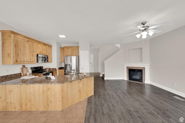 602 E Wyngate Pointe Ln S, Draper, UT 84020 - kitchen featuring stainless steel appliances, dark stone counters, a peninsula, light brown cabinetry, and a ceiling fan