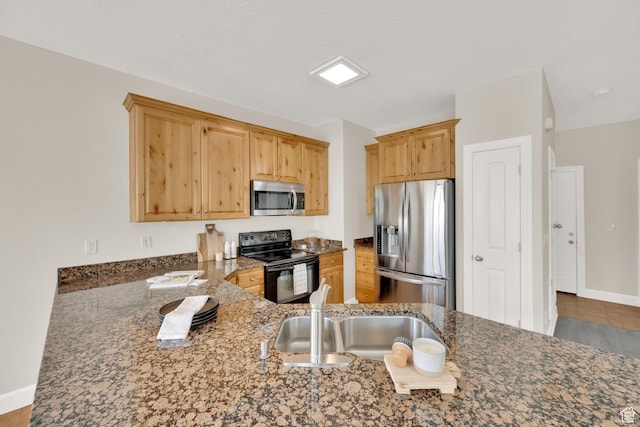 602 E Wyngate Pointe Ln S, Draper, UT 84020 - kitchen featuring appliances with stainless steel finishes, dark stone countertops, light brown cabinetry, and tile patterned floors