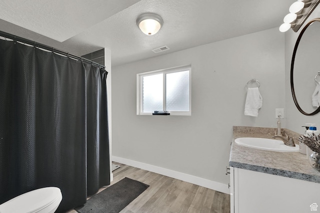 6337 S Coybrook Dr, Taylorsville, UT 84129 - full bathroom with vanity, wood finished floors, a textured ceiling, and a shower with shower curtain