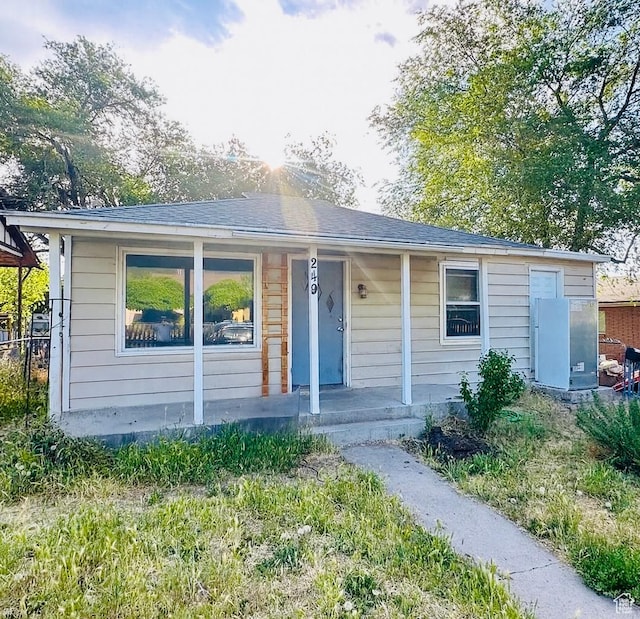 249 N Broadway St E, Tooele, UT 84074 - view of front of house featuring covered porch and a shingled roof