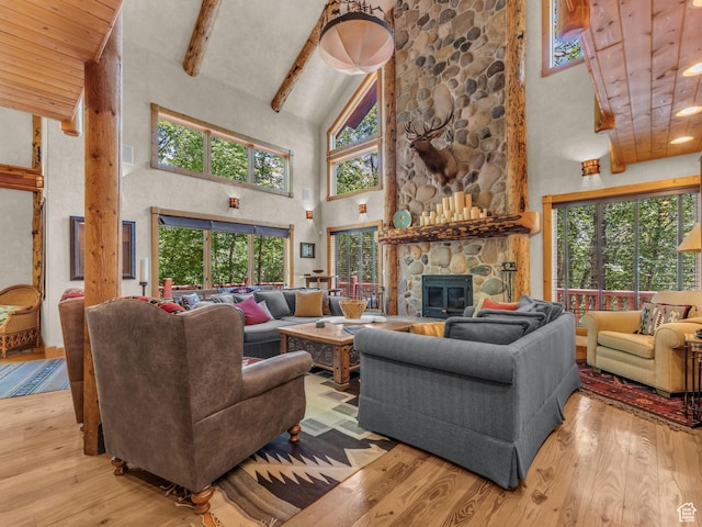 8998 Timphaven Rd, Sundance, UT 84604 - living room with high vaulted ceiling, wood finished floors, beam ceiling, a fireplace, and recessed lighting