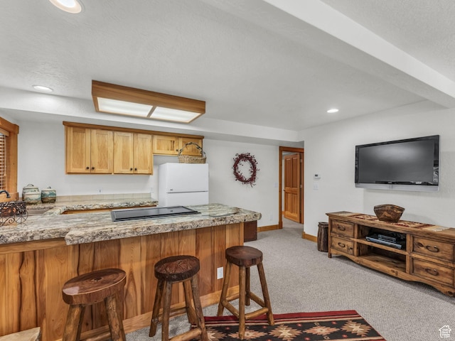8998 Timphaven Rd, Sundance, UT 84604 - kitchen featuring white refrigerator, cooktop, light carpet, a kitchen bar, and recessed lighting