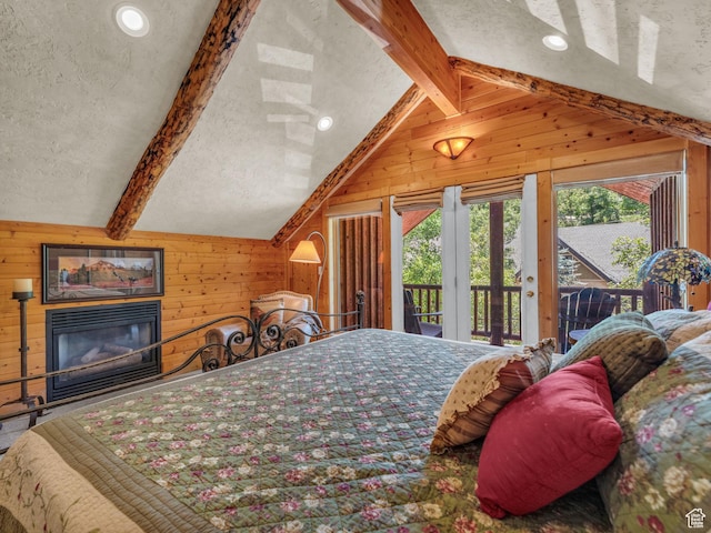 8998 Timphaven Rd, Sundance, UT 84604 - bedroom with wood walls, access to exterior, a glass covered fireplace, and a textured ceiling