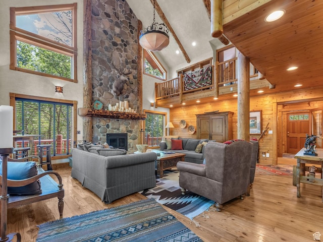 8998 Timphaven Rd, Sundance, UT 84604 - living area with high vaulted ceiling, wood-type flooring, a stone fireplace, recessed lighting, and beam ceiling