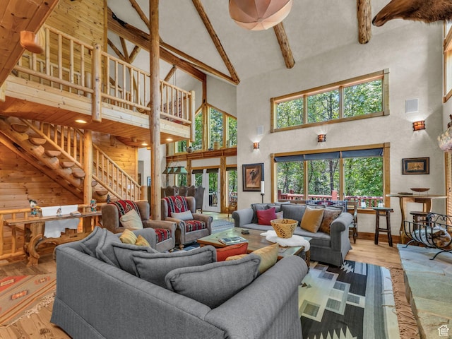 8998 Timphaven Rd, Sundance, UT 84604 - living area with high vaulted ceiling, beam ceiling, wood finished floors, and stairway