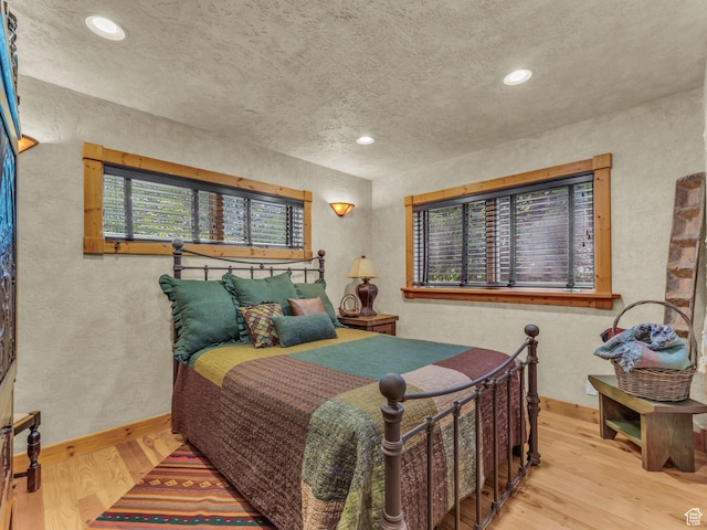 8998 Timphaven Rd, Sundance, UT 84604 - bedroom featuring a textured wall, wood finished floors, a textured ceiling, and recessed lighting