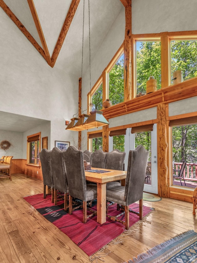 8998 Timphaven Rd, Sundance, UT 84604 - dining space featuring high vaulted ceiling, wood-type flooring, beamed ceiling, and plenty of natural light