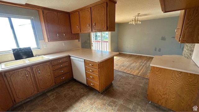 4220 S 2075 W, Roy, UT 84067 - kitchen with dishwasher, brown cabinetry, healthy amount of natural light, and a textured ceiling