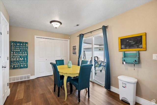 3042 S Festival Dr W, West Valley City, UT 84120 - dining room featuring dark wood-type flooring and baseboards