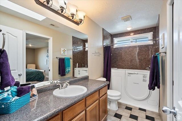 3042 S Festival Dr W, West Valley City, UT 84120 - bathroom with vanity, ensuite bathroom, and a textured ceiling