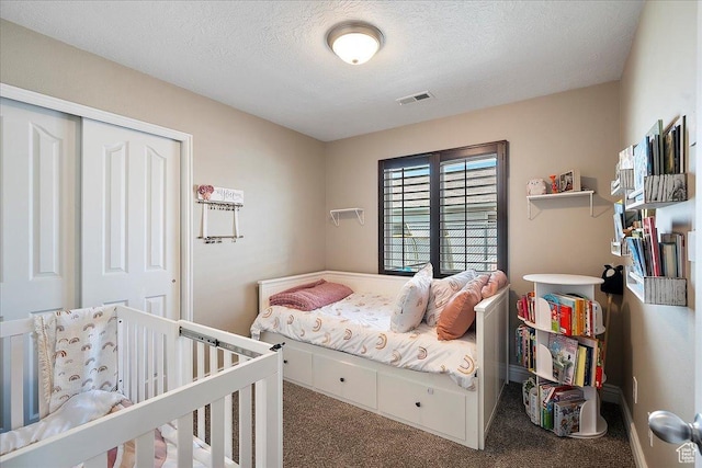 3042 S Festival Dr W, West Valley City, UT 84120 - bedroom featuring carpet flooring, a textured ceiling, and a closet