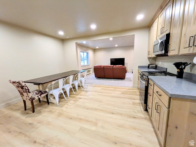 251 N Summit Dr, Beaver, UT 84713 - kitchen featuring stainless steel microwave, electric stove, light wood-style floors, dark countertops, and recessed lighting