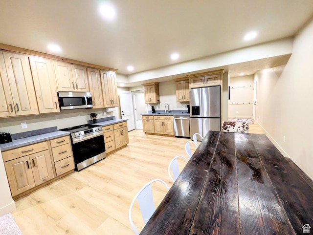 251 N Summit Dr, Beaver, UT 84713 - kitchen featuring appliances with stainless steel finishes, light brown cabinets, recessed lighting, light wood-style floors, and dark countertops