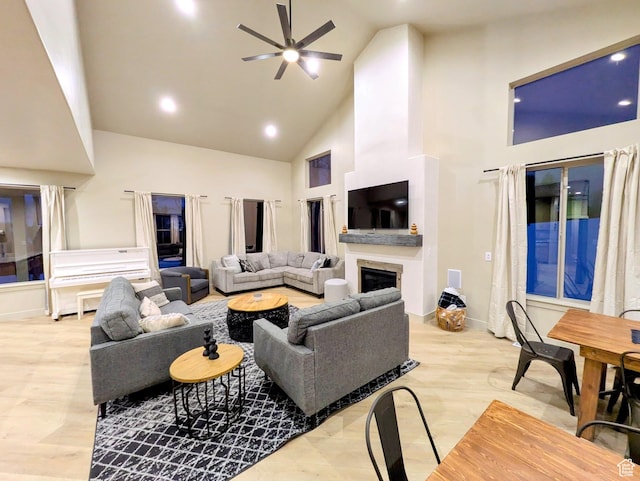251 N Summit Dr, Beaver, UT 84713 - living room with high vaulted ceiling, a ceiling fan, a glass covered fireplace, recessed lighting, and light wood-style flooring