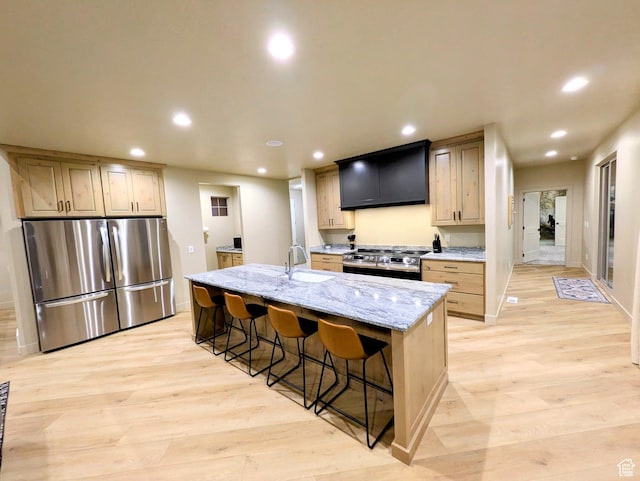 251 N Summit Dr, Beaver, UT 84713 - kitchen featuring appliances with stainless steel finishes, ventilation hood, recessed lighting, light wood-style floors, and a breakfast bar area