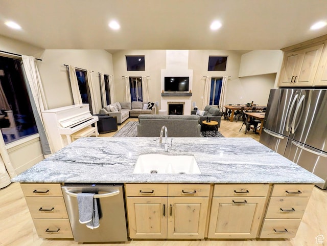 251 N Summit Dr, Beaver, UT 84713 - kitchen featuring stainless steel appliances, light brown cabinetry, light stone countertops, a center island with sink, and recessed lighting