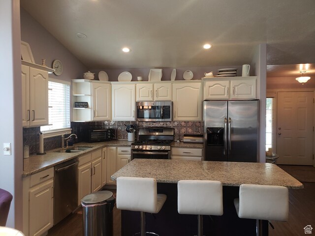 62 S 100 E, Kaysville, UT 84037 - kitchen with stainless steel appliances, a kitchen bar, tasteful backsplash, light stone counters, and recessed lighting