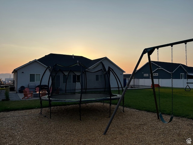 1048 N 200 E, Nephi, UT 84648 - back of property with a trampoline, a patio area, and a playground