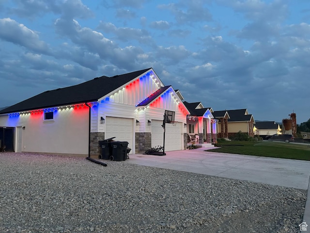 1048 N 200 E, Nephi, UT 84648 - view of side of property with a garage, board and batten siding, concrete driveway, and stone siding