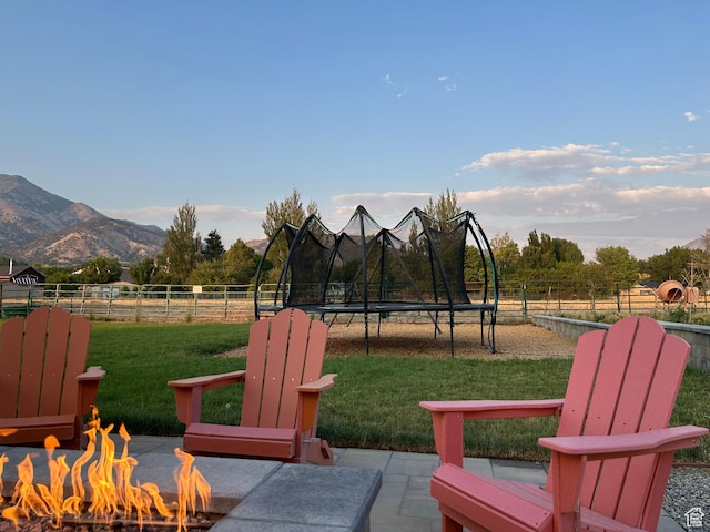 1048 N 200 E, Nephi, UT 84648 - view of patio with a fire pit, a trampoline, and a mountain view