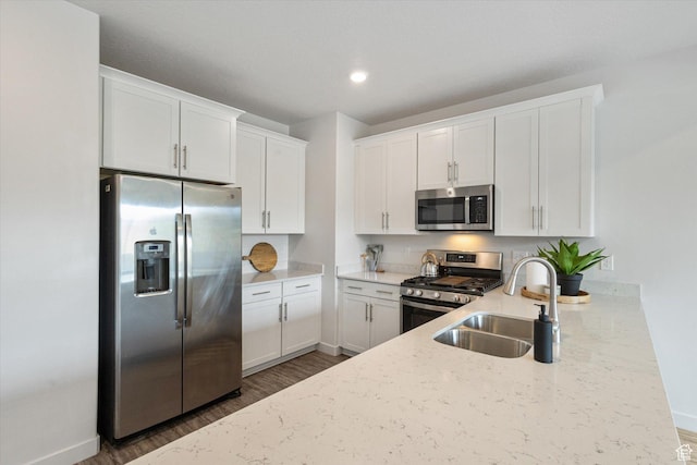 1011 W Lapis Fields Way S, Bluffdale, UT 84065 - kitchen featuring appliances with stainless steel finishes, dark wood finished floors, light stone counters, white cabinets, and recessed lighting