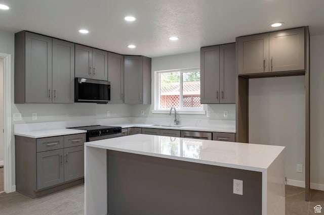 8483 S Terrace Dr, Sandy, UT 84093 - kitchen with stainless steel microwave, gray cabinets, black range with electric stovetop, recessed lighting, and a kitchen island